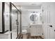Bright bathroom featuring a modern vanity, toilet, and a glass-enclosed shower at 777 Whispering Oak Dr, Castle Rock, CO 80104