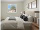 Bedroom featuring a comfortable bed and a view of the neighborhood through the windows at 777 Whispering Oak Dr, Castle Rock, CO 80104