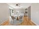 Bright dining room with hardwood floors featuring a modern table, stylish chairs, and views into the kitchen at 777 Whispering Oak Dr, Castle Rock, CO 80104