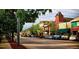 Charming streetscape with historic buildings, mature trees, and street parking along the sidewalk at 777 Whispering Oak Dr, Castle Rock, CO 80104