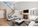 Bright living room featuring a fireplace, built-in shelving, and large windows providing ample natural light at 777 Whispering Oak Dr, Castle Rock, CO 80104