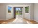 Bright sunroom with hardwood floors and large windows providing ample natural light and views of the backyard at 777 Whispering Oak Dr, Castle Rock, CO 80104