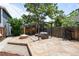 Backyard featuring a stone patio, firepit, shed, pergola, and mature trees at 14 S Lincoln St # 16, Denver, CO 80209