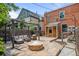 Cozy backyard featuring a stone patio, fire pit, and outdoor seating area with a pergola, perfect for entertaining at 14 S Lincoln St # 16, Denver, CO 80209