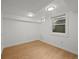Basement area featuring hardwood floors, a window, and white walls at 14 S Lincoln St # 16, Denver, CO 80209