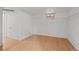 Unfinished basement with a painted brick wall, small window, and wood laminate flooring at 14 S Lincoln St # 16, Denver, CO 80209