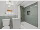 Stylish bathroom featuring unique green tiling, a shower-tub combo, and a modern vanity, offering a relaxing space at 14 S Lincoln St # 16, Denver, CO 80209