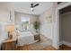 Cozy bedroom featuring hardwood floors, wainscoting, and a comfortable bed next to a window at 14 S Lincoln St # 16, Denver, CO 80209