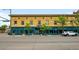 Commercial building featuring large storefront windows, vintage brickwork, and street parking at 14 S Lincoln St # 16, Denver, CO 80209