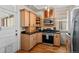 Well-equipped kitchen with wooden cabinets, stainless steel appliances, and ample counter space for meal preparation and cooking at 14 S Lincoln St # 16, Denver, CO 80209