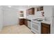 Basement kitchen features updated appliances, white countertops, and brown cabinets at 14 S Lincoln St # 16, Denver, CO 80209