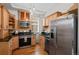 Updated kitchen featuring stainless steel appliances, granite countertops, wood cabinets and hardwood floors at 14 S Lincoln St # 16, Denver, CO 80209