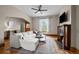 Inviting living room with hardwood floors, a fireplace, and a large window providing natural light and a ceiling fan at 14 S Lincoln St # 16, Denver, CO 80209