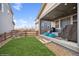 Landscaped backyard with grassy area and covered patio at 9334 Kilmer Way, Arvada, CO 80007