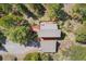 Aerial view shows a rustic house with a large deck surrounded by trees at 1278 Aspen Dr, Evergreen, CO 80439