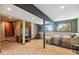 Finished basement with bedroom, TV, steps to upper level, and view window at 1278 Aspen Dr, Evergreen, CO 80439