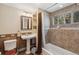 Bathroom with tile tub surround, decorative tile details, and a pedestal sink at 1278 Aspen Dr, Evergreen, CO 80439