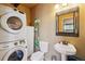 Functional bathroom with stacked washer and dryer, single vanity and medicine cabinet at 1278 Aspen Dr, Evergreen, CO 80439