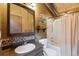 Bathroom featuring a vanity with a mirror, a toilet, and a shower-tub combo at 1278 Aspen Dr, Evergreen, CO 80439
