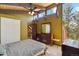 Bedroom with high ceilings, view window, ceiling fan, and dresser with large mirror at 1278 Aspen Dr, Evergreen, CO 80439