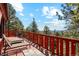 Outdoor living space with lounge chairs and furniture on an expansive deck with stunning views at 1278 Aspen Dr, Evergreen, CO 80439