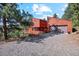 A distinctive modern two-story home with a two-car garage and rustic wood siding at 1278 Aspen Dr, Evergreen, CO 80439