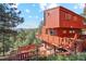 Charming exterior view with a large elevated deck showcasing the mountain views and wooded scenery at 1278 Aspen Dr, Evergreen, CO 80439