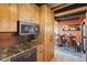 Galley kitchen with granite countertops, stainless appliances and plenty of cabinet space at 1278 Aspen Dr, Evergreen, CO 80439