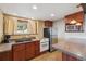 Functional kitchen with appliances, cabinets, and a window overlooking the outdoors at 1278 Aspen Dr, Evergreen, CO 80439