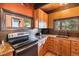 Kitchen area featuring natural wood cabinets and stainless steel appliances at 1278 Aspen Dr, Evergreen, CO 80439
