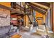 Open-concept living area with a dining area, kitchen, and cozy seating arrangement with a vaulted ceiling at 1278 Aspen Dr, Evergreen, CO 80439