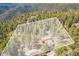 Aerial view of the lot lines showcasing a house surrounded by dense trees and mountain views at 1278 Aspen Dr, Evergreen, CO 80439