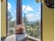 Seating area by the view window with view of mountain tops and trees outside at 1278 Aspen Dr, Evergreen, CO 80439
