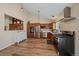 Bright kitchen with stainless steel appliances, wood cabinetry, and hardwood floors at 1161 S Marshall St, Lakewood, CO 80232