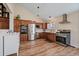 Spacious kitchen features stainless steel appliances, wood cabinets, and hardwood floors at 1161 S Marshall St, Lakewood, CO 80232