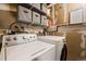 Functional laundry area featuring modern washer and dryer for easy chores at 1161 S Marshall St, Lakewood, CO 80232