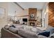Cozy living area with a stone fireplace, large sectional, and skylight at 1161 S Marshall St, Lakewood, CO 80232