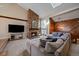 Cozy living area with a stone fireplace, large sectional, and skylight at 1161 S Marshall St, Lakewood, CO 80232