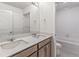 Bathroom featuring a double sink vanity and a tub and shower combination at 14269 Beebalm Ave, Parker, CO 80134