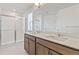 Bathroom featuring a glass enclosed shower, double sink vanity and white countertops at 14269 Beebalm Ave, Parker, CO 80134
