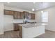 Modern kitchen island with granite countertops, stylish pendant lighting, and stainless steel appliances at 14269 Beebalm Ave, Parker, CO 80134