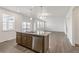 Kitchen island featuring a stainless steel dishwasher and double sink at 14269 Beebalm Ave, Parker, CO 80134