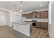Bright kitchen featuring granite countertops, stainless steel appliances, and wood-look flooring at 14269 Beebalm Ave, Parker, CO 80134