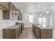 Spacious kitchen with dark wood cabinetry, granite countertops, and stainless steel appliances at 14269 Beebalm Ave, Parker, CO 80134