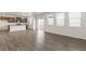 Open concept living space with hardwood floors, abundant natural light, and modern kitchen at 14269 Beebalm Ave, Parker, CO 80134