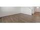 Open-plan living room featuring vinyl flooring, white walls, and staircase at 14269 Beebalm Ave, Parker, CO 80134