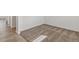 Corner view of a room with plush carpeting, white walls, and wood-look vinyl flooring at 14269 Beebalm Ave, Parker, CO 80134