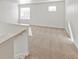 Loft area with neutral carpet and natural light from two windows at 14269 Beebalm Ave, Parker, CO 80134