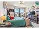 Bedroom with a large window and a large television with decorations at 4736 S Buchanan St, Aurora, CO 80016