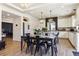 Open-concept dining room with modern décor, a large table for gatherings, and seamless flow to the kitchen at 4736 S Buchanan St, Aurora, CO 80016